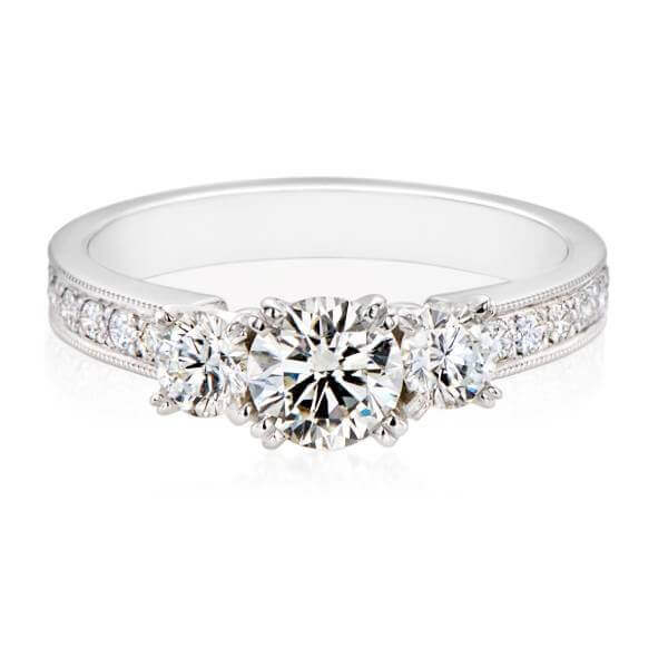 Brilliant cut three stone diamond ring